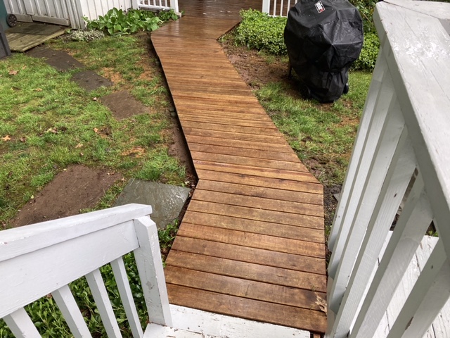 After pressure washing and staining the walkway looks inviting and great.